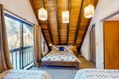 a bedroom with two beds and a large window at Hillside Haven in Soda Springs