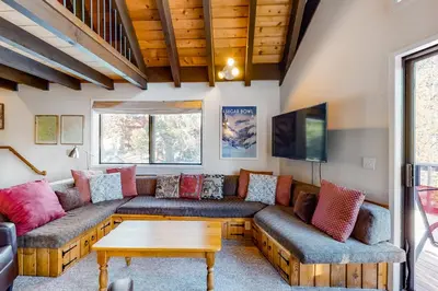 a living room with a couch and a table at Hillside Haven in Soda Springs