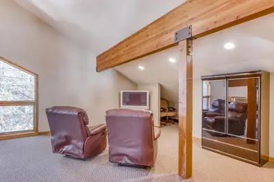 a living room with two chairs and a tv at Four Seasons Lakeside in Soda Springs