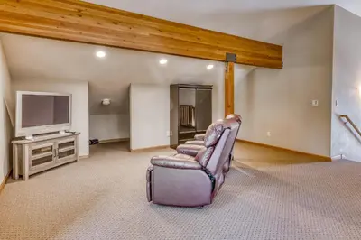 a living room with a chair and a tv at Four Seasons Lakeside in Soda Springs