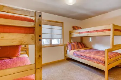 a bedroom with two bunk beds and a window at Four Seasons Lakeside in Soda Springs