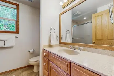 a bathroom with a sink and a toilet and a mirror at Beaver Cove Lodge in Truckee