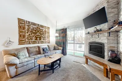a living room with a couch and a fireplace at Crestview 36 in Mammoth Lakes