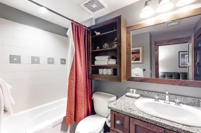 a bathroom with a sink and a tub and a toilet at Woodwinds 19 in Mammoth Lakes