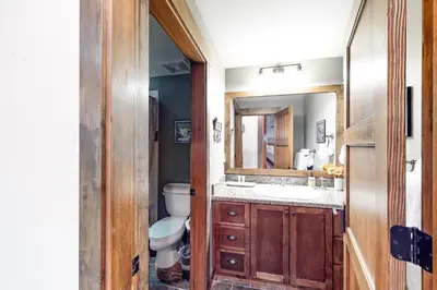 a bathroom with a toilet and a sink and a mirror at Woodwinds 19 in Mammoth Lakes