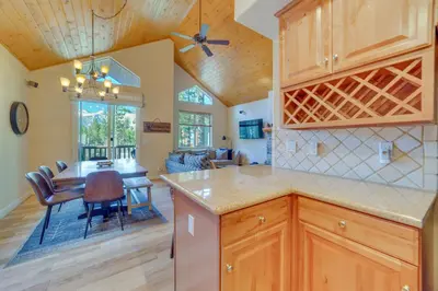 a kitchen with a table and a dining room at Central Townhome Less Than 1 Mi to The Village at Mammoth! in Mammoth Lakes