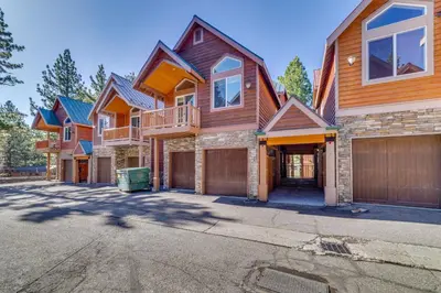 a large house with a garage in a driveway at Central Townhome Less Than 1 Mi to The Village at Mammoth! in Mammoth Lakes