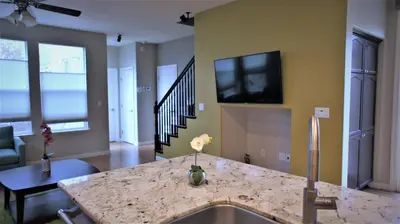 a kitchen with a sink and a tv on a wall at Modern Luxury Living, relax and enjoy your stay! in Rancho Cordova