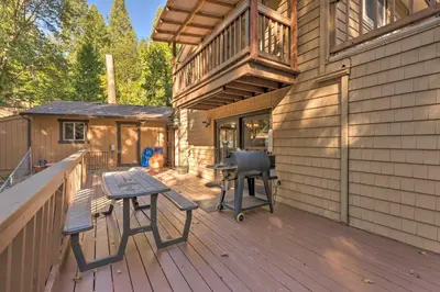 a wooden deck with a table and chairs on it at Near Hiking Trails Cabin with Deck in Pioneer! in Pioneer