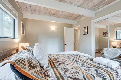 a bedroom with a king sized bed and a window at Family Cabin in Blue Lake Springs, Near Town! in Arnold