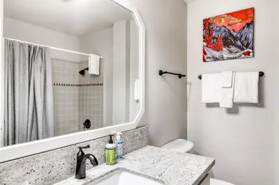 a white bathroom with a sink and a mirror at Captains Quarters Retreat in Zephyr Cove