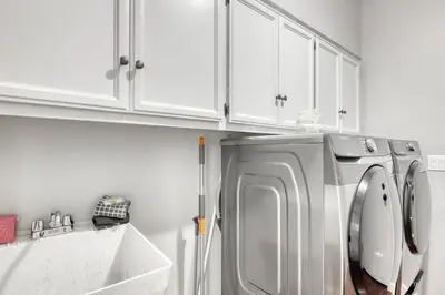 a white kitchen with a refrigerator and a sink at Captains Quarters Retreat in Zephyr Cove