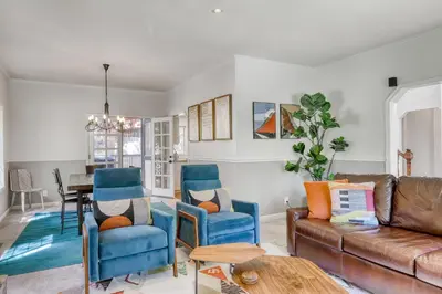a living room with a brown couch and blue chairs at Captains Quarters Retreat in Zephyr Cove