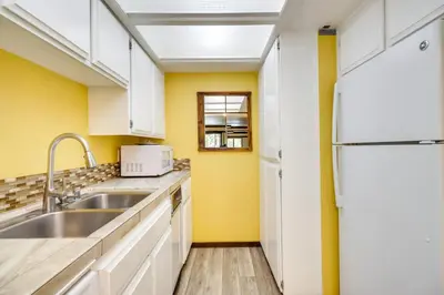 a kitchen with yellow walls and a sink at Walk to Ski Shuttle Incline Village Condo in Incline Village