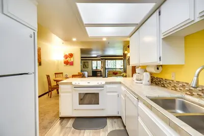 a kitchen with white cabinets and a sink at Walk to Ski Shuttle Incline Village Condo in Incline Village