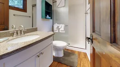 a bathroom with a toilet and a sink and a mirror at Meadow Ridge #28 condo in Mammoth Lakes