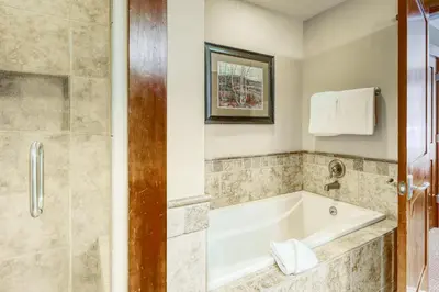 a bathroom with a tub and a shower at Northstar Village #410 in Kingswood Estates
