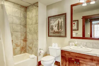 a bathroom with a toilet and a tub and a sink at Northstar Village #410 in Kingswood Estates