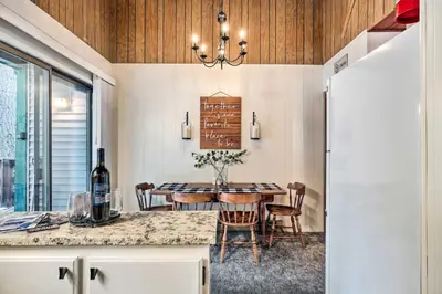 a dining room with a table with a bottle of wine at Pinecrest Retreat with Fireplace! in Pinecrest