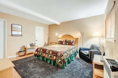 a large bedroom with a bed and a chair at Tahoe Treetop Escape in Stateline