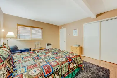 a bedroom with a bed and a large window at Tahoe Treetop Escape in Stateline
