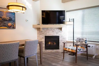 a living room with a table and a fireplace at Tahoe Trail Resort in Stateline