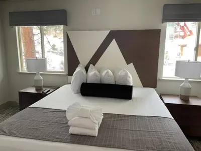 a bedroom with a bed with white towels on it at Tahoe Trail Resort in Stateline