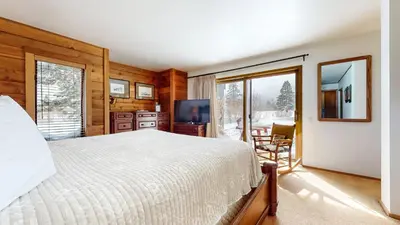 a bedroom with a bed and a tv and a window at Snowcreek III #448 condo in Mammoth Lakes