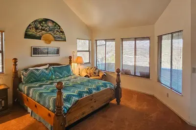 a bedroom with a bed in a room with windows at Tee Time Terrace in Groveland