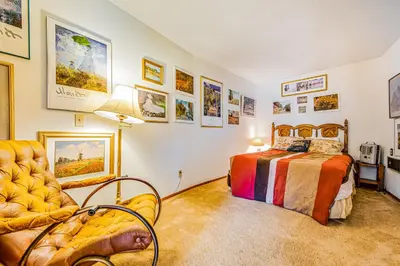 a bedroom with a bed and a chair at Luring Lakefront Landing in Groveland