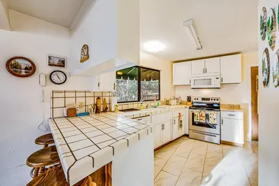 a kitchen with white cabinets and a counter top at Luring Lakefront Landing in Groveland