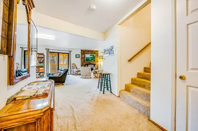 a living room with a staircase and a living room at Luring Lakefront Landing in Groveland