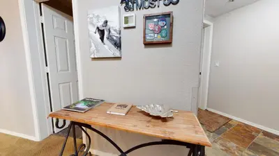a table with a book on it next to a wall at Silver Bear #30 condo in Mammoth Lakes