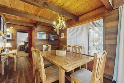 a dining room with a wooden table and chairs at Indian Hill Hush in Truckee