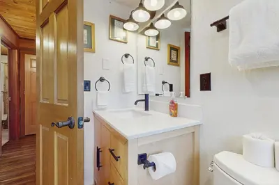 a bathroom with a sink and a mirror and a toilet at Indian Hill Hush in Truckee