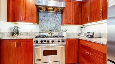 a kitchen with wooden cabinets and a stove top oven at Obsidian #7 home in Mammoth Lakes