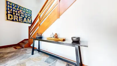 a room with a table and a stair case at Obsidian #7 home in Mammoth Lakes