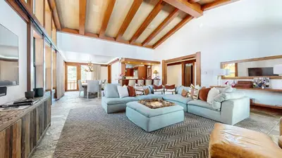a living room with blue couches and a tv at Obsidian #7 home in Mammoth Lakes