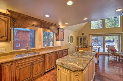 a large kitchen with wooden cabinets and a large island at 4 Mi to Dtwn Truckee Tahoe Donner Home with Hot Tub in Truckee