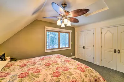 a bedroom with a bed and a ceiling fan at 4 Mi to Dtwn Truckee Tahoe Donner Home with Hot Tub in Truckee