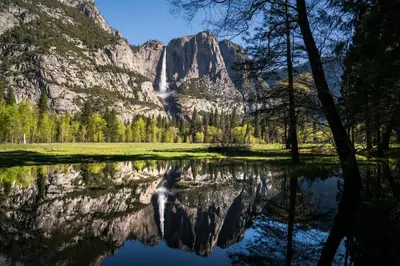 a reflection of a mountain in a lake at Fairfield Inn & Suites by Marriott Oakhurst Yosemite in Oakhurst