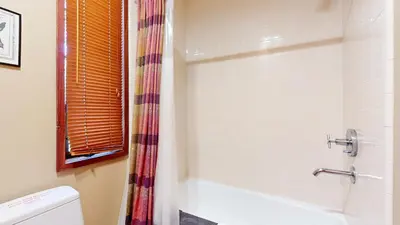 a bathroom with a shower and a tub and a toilet at Rainbow Villas #1 condo in Mammoth Lakes