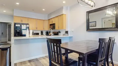 a kitchen with a wooden table and a mirror at Mammoth Green #102 condo in Mammoth Lakes