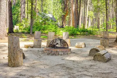 a park with a fire pit in the woods at Cabin with Deck and Fire Pit in Blue Lake Springs! in Arnold