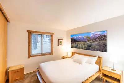 a bedroom with a white bed and a window at Modern 1 bedroom in Ski Trails condo in Kingswood Estates