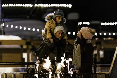 a man with a child on his shoulders at night at Modern 1 bedroom in Ski Trails condo in Kingswood Estates