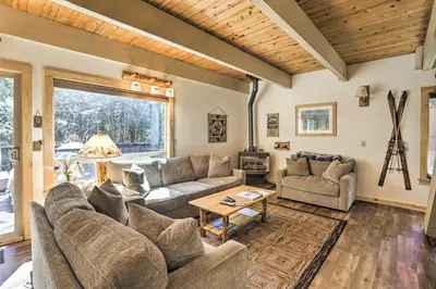 a living room with a couch and a table at 3 Mi to Lake Tahoe Quiet Incline Village Cabin! in Incline Village