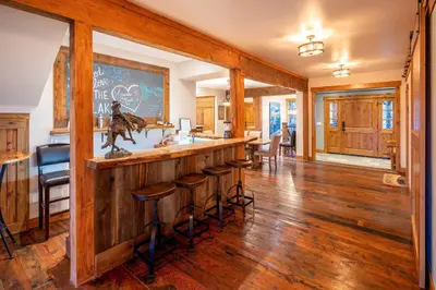 a kitchen with a wooden bar with stools at 4 Mi to Diamond Peak Ski Resort Gem with Hot Tub in Incline Village
