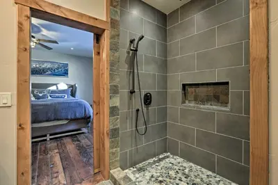 a master bathroom with a shower and a bed at 4 Mi to Diamond Peak Ski Resort Gem with Hot Tub in Incline Village