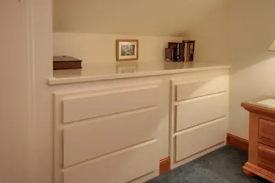 a kitchen with white drawers and a shelf at 92R Jolie Cabin in North Wawona
